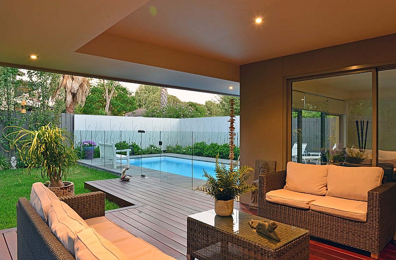 Integration of the rear family room, outdoor living area, garden and pool area.