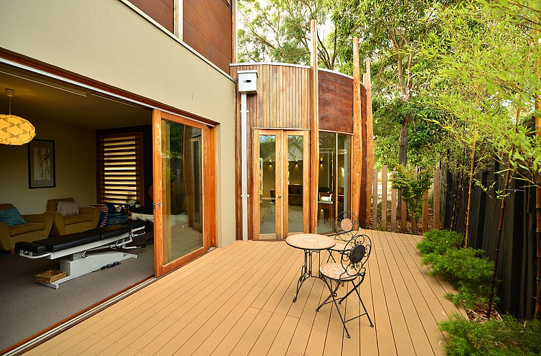 An outdoor area adjacent the treatment room, doors at the end are to a circular room for group use.
