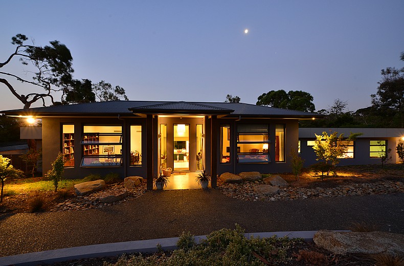 The house and garden lit up at night
