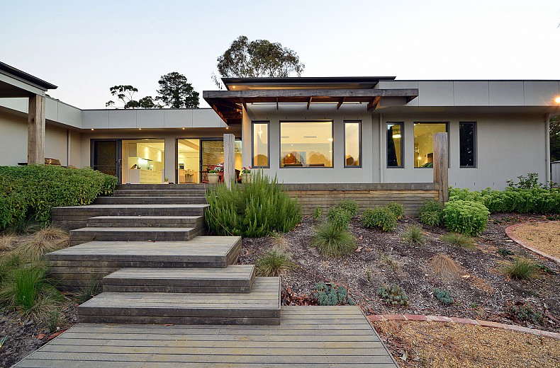 Decking platforms cascade down to the lower garden with outdoor fire from the extensive rear deck and alfresco area.