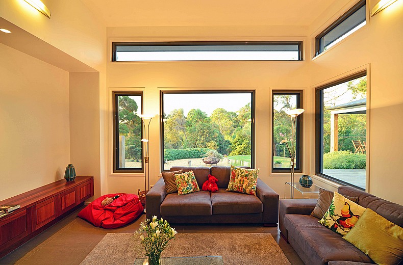 High ceiling and windows overlook the decks and multi-level gardens.